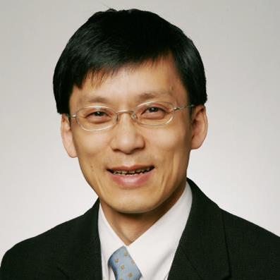 A head-shot photograph of Christopher Chen, PhD. He is smiling at the camera in a dark suit and light tie. He wears thin framed glasses.