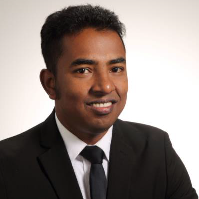 A headshot of Munsur Rahman, PhD-PE-ACTAR wearing a black suit and tie.