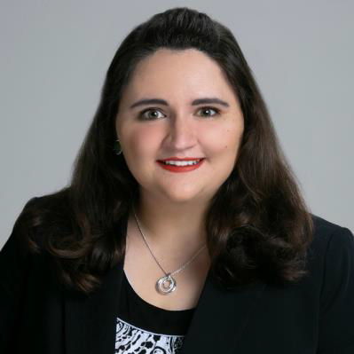 A photograph of Fatiesa Sulejmani, PhD. SHe wears a black suit and a silver necklace.