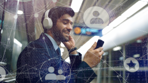 businessman on a subway holds a phone with a graphic overlay that hints at virtual connection with circles connected in a web of lines